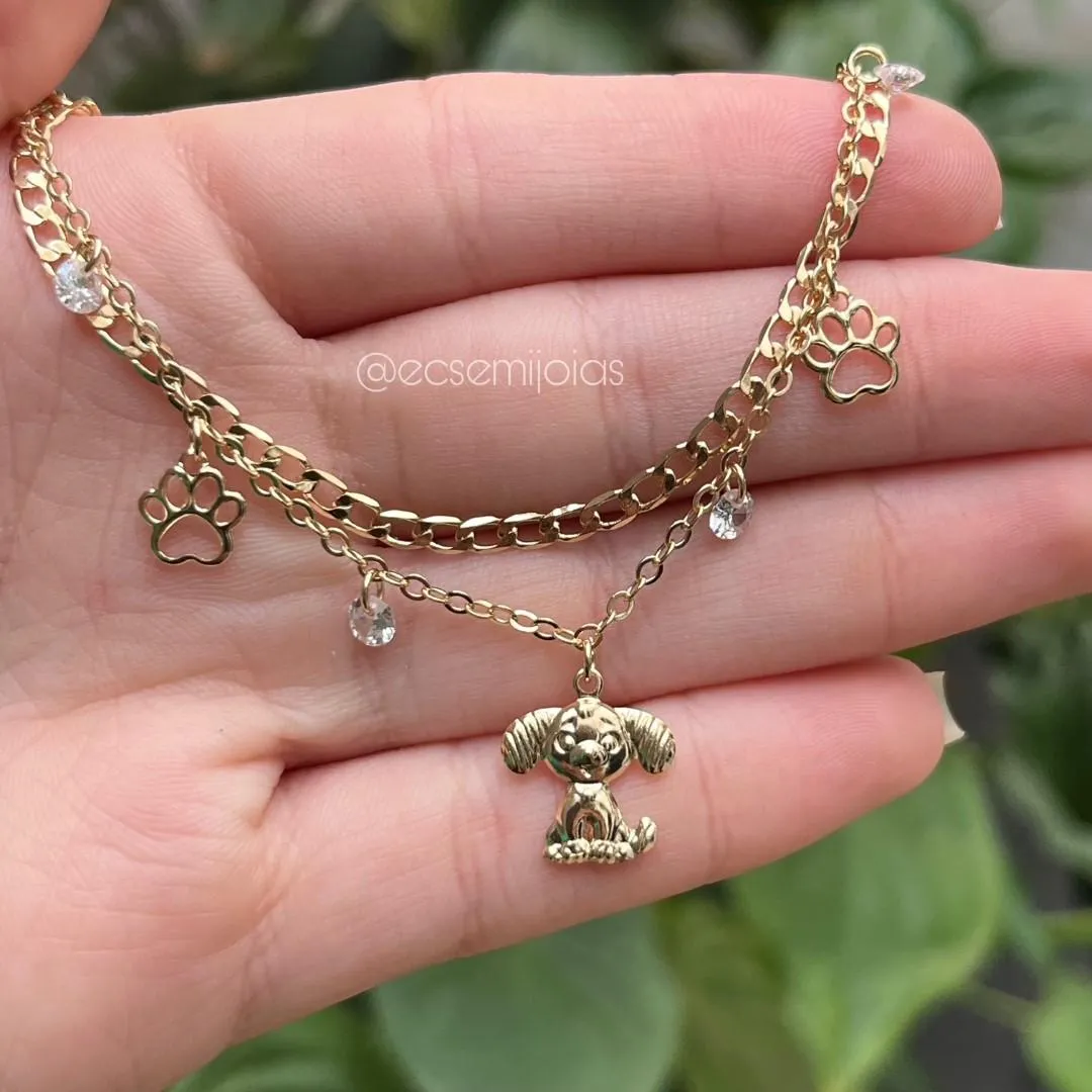Pulseira dupla com elo grumet e português com cachorro e zircônias penduradas - banhado a ouro 18k