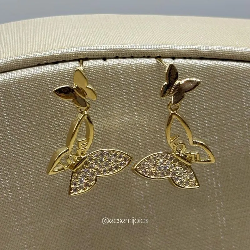 Brinco com borboleta pequena lisa e borboleta maior cravejada pendurada - banhado a ouro 18k