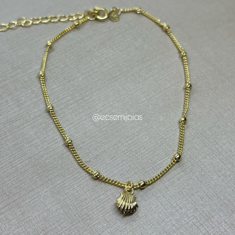 Tornozeleira grumet fininha com bolinhas lisas e concha pendurada - 23cm + extensor - banhado a ouro 18k